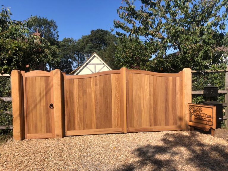 Fence and posts installed along a driveway
