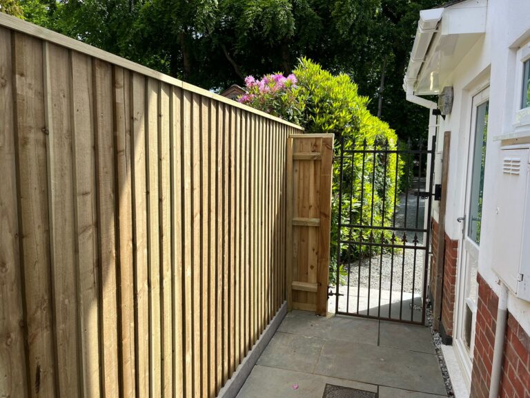 Close-boarded timber fence with concrete posts, fitted by Turners